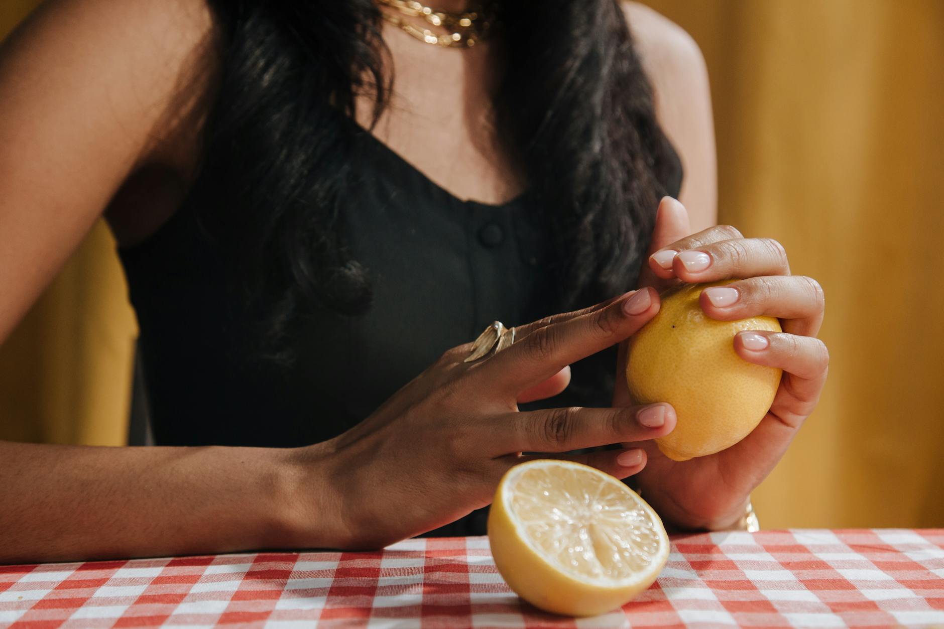 Hand holding a colorful vibrator against a minimalistic purple backdrop, emphasizing sensuality and self-care.