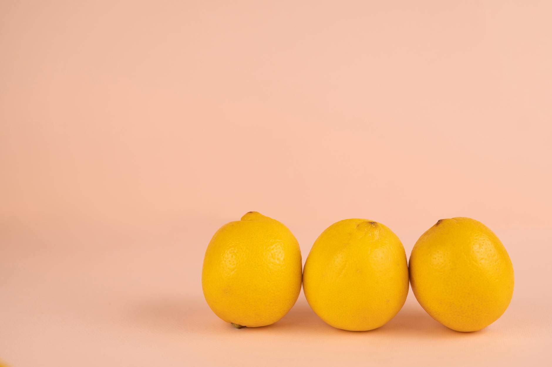 Vibrant arrangement of colorful adult toys including lemon vibrators on a bright yellow surface
