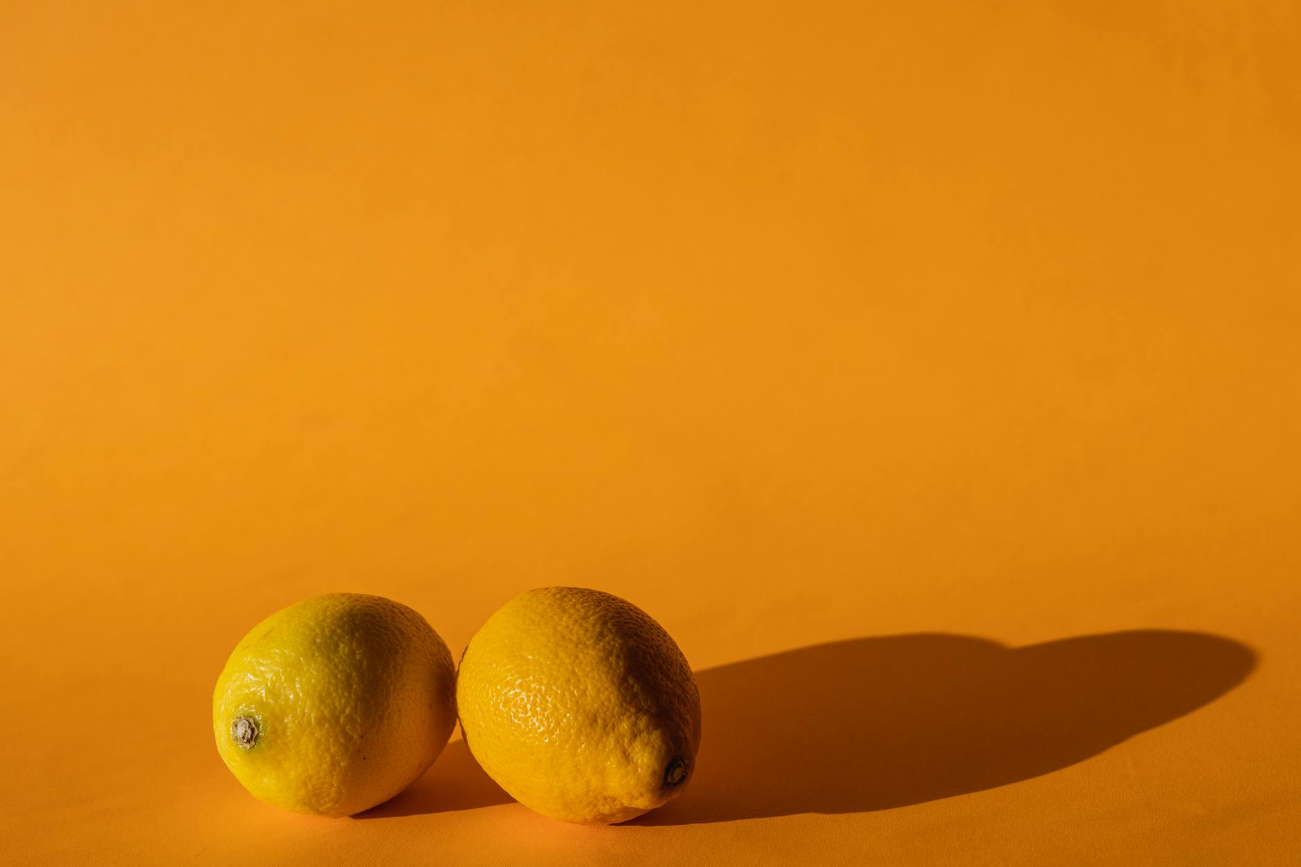 A bright yellow silicone vibrator surrounded by fresh fruits, symbolizing renewal and pleasure recovery